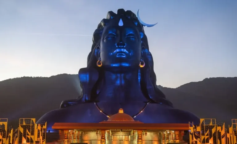 Giant Adiyogi Shiva statue with a crescent moon on the head, located at the Isha Yoga Center in Coimbatore, India, during sunset.