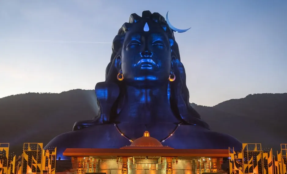 Giant Adiyogi Shiva statue with a crescent moon on the head, located at the Isha Yoga Center in Coimbatore, India, during sunset.