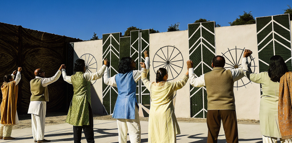 Group of devotees in traditional attire holding hands during Navratri, showing unity and the power of navratri colours (नवरात्रि के रंग) in collective celebration.
